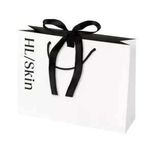 Bolsa de regalo pequeña HL/Skin blanca con lazo negro, ideal para presentar productos de cuidado de la piel