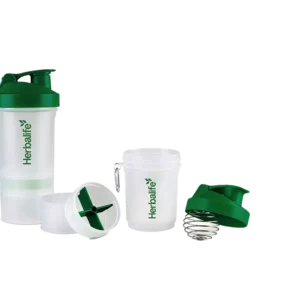 Shaker Herbalife transparente con tapa verde y compartimentos desmontables.